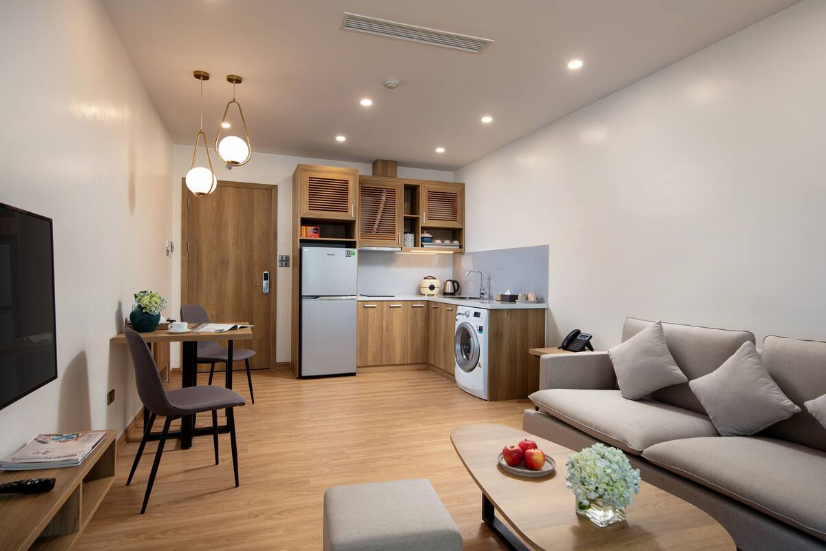 A compact living space with a kitchenette, a dining area, and a seating area.