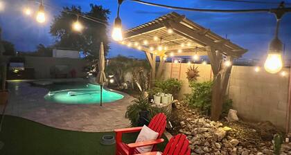 A pet-friendly cozy 4 bedroom home with a resort style pool in the backyard.