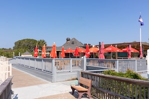 Enjoy a meal under the shade of our outdoor seating area, where tables are set amidst a tranquil atmosphere.