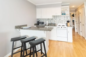 Enjoy cooking in this well-equipped kitchen with a central island and appliances.