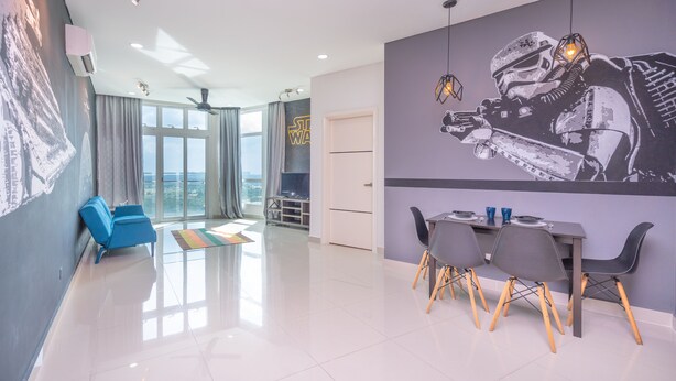 A modern living room with a dining area, a large window, and a Star Wars-themed wall mural. - OYO Home 89731 Amazing 1br 1medini (Iskandar Puteri)