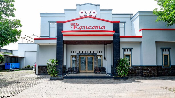 L’extérieur de l’hôtel Kencana se distingue par sa façade moderne, son entrée imposante et les deux plantes en pot qui l’encadrent de chaque côté.