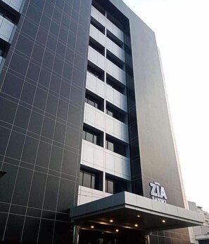 A modern hotel building with a prominent 'ZIA SANNO' sign at the entrance. - Hotel Zia Sanno Jakarta - Pluit (Jakarta)