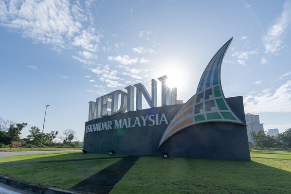 A large sign with the text "MEDINA MALAYSIA" and a stylized logo.
