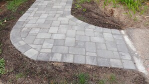 A brick pathway leading to a patio area with a table and chairs, surrounded by greenery and a wooden fence. - ** Labor day on 3day min. Beach 0.7 Mi walk- Craigville & Covell. A/C, bikes. (Barnstable)