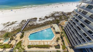 A resort with a pool, beach, and ocean view.