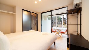 Habitación de hotel moderna con una cama grande, un escritorio y vistas al exterior.