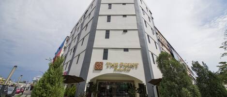 A hotel with a modern design, featuring a prominent entrance and a sign that reads "The Point Boutique Hotel."