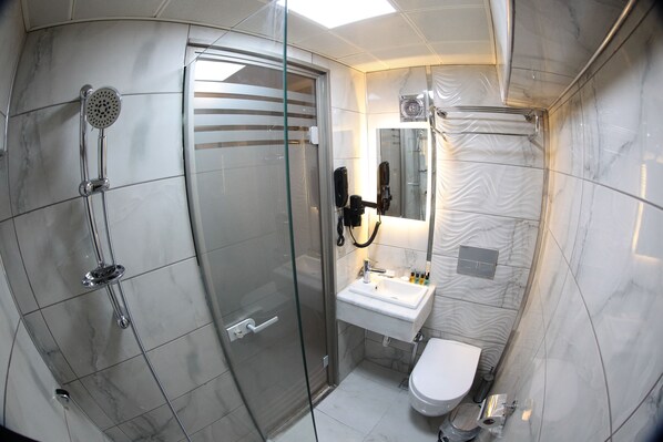 A bathroom with a glass-enclosed shower, a sink, and a toilet. - X-Nellyi Boutique Hotel (Istanbul)
