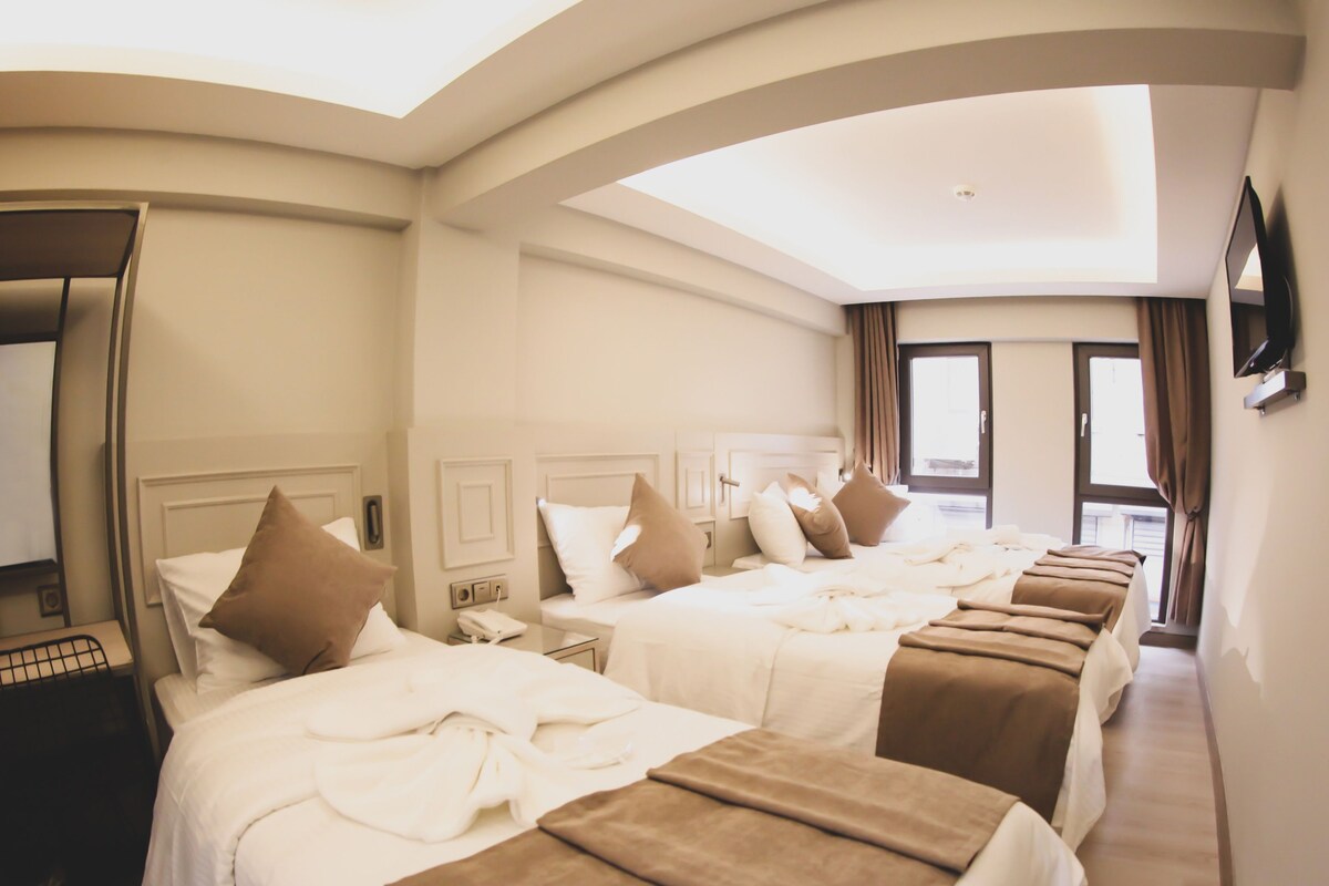 Family Quadruple Room | Minibar, in-room safe, desk, laptop workspace