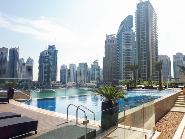 Outdoor pool, pool loungers - Luton Vacation Homes Damac Heights (Dubai)