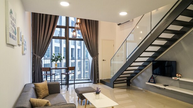 A modern living room with a sofa, a coffee table, and a staircase. - Minsu Ekocheras (Kuala Lumpur)