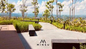 A rooftop garden with a pathway, benches, and young trees. - Minsu Ekocheras (Kuala Lumpur)