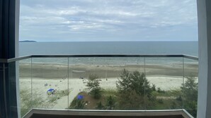 A view from a balcony overlooking a beach with a clear sky. - Timurbay by Seascape (Kuantan)