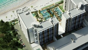 A high-rise hotel with a rooftop pool, beach access, and lush landscaping. - Timurbay by Seascape (Kuantan)
