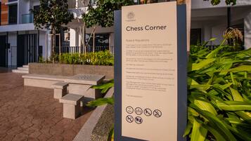 A signboard titled "Chess Corner" with rules and regulations.