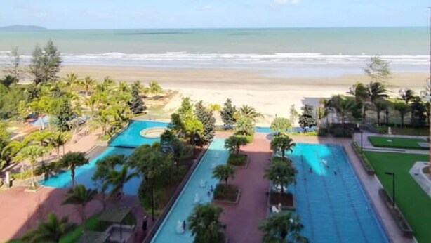 A resort with a large pool area, a beach view, and a well-maintained landscape. - Timurbay by Seascape (Kuantan)