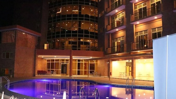 A hotel with a swimming pool, multiple floors, and balconies. - Sainte Famille Hotel (Kigali)