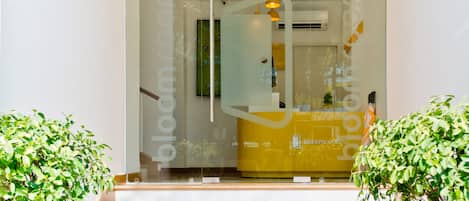 A modern entrance with a glass door leading to a reception area.