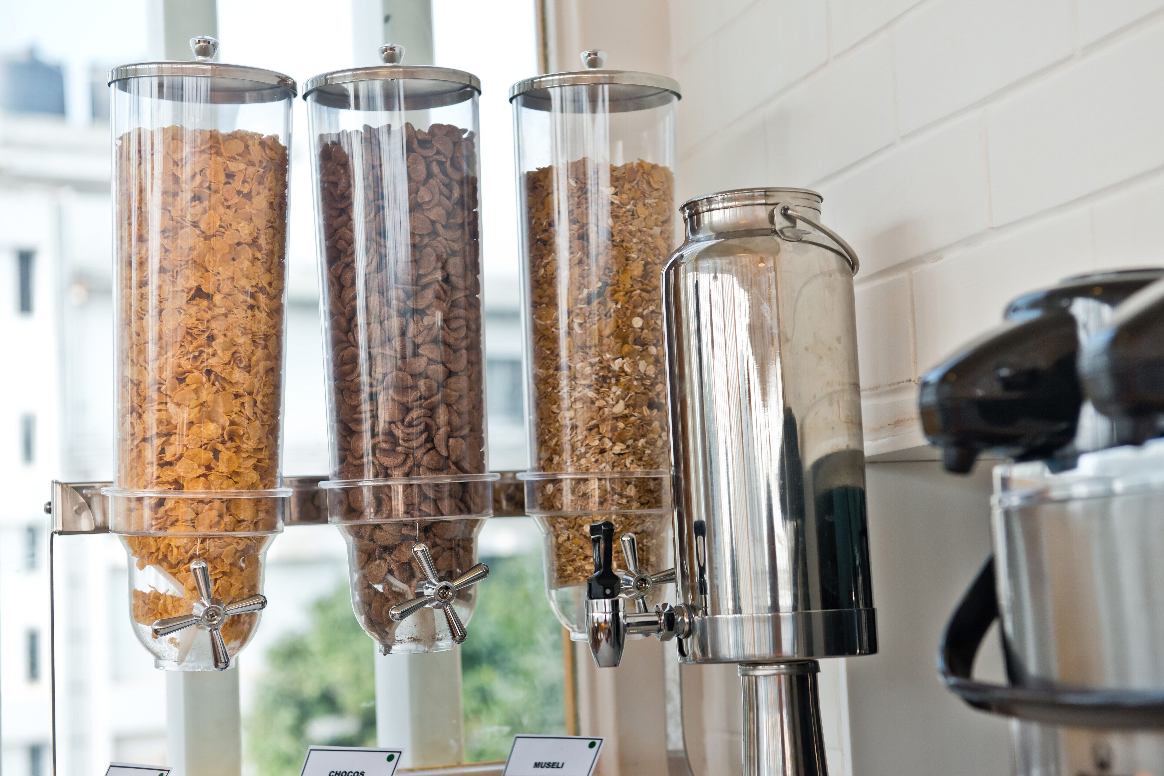 A coffee dispenser with multiple containers of different coffee grounds.