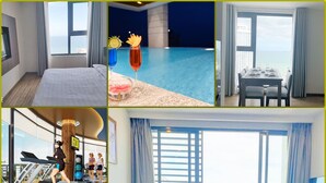 A hotel room with a bed, a dining area with a table set for two, a gym with treadmills, a balcony with a sofa and chairs, and a cityscape view at night. - Apartment Beach Nha Trang Sea View (Nha Trang)