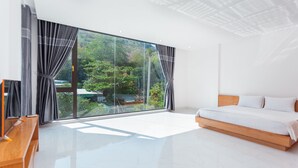 A modern bedroom with a large window, a wooden bed, and a wooden bench. - Villa Viba (Ho Chi Minh City)