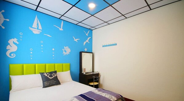 A hotel room with a blue wall, a green headboard, a bed with white bedding, a nightstand with a mirror, and a sign on the wall.