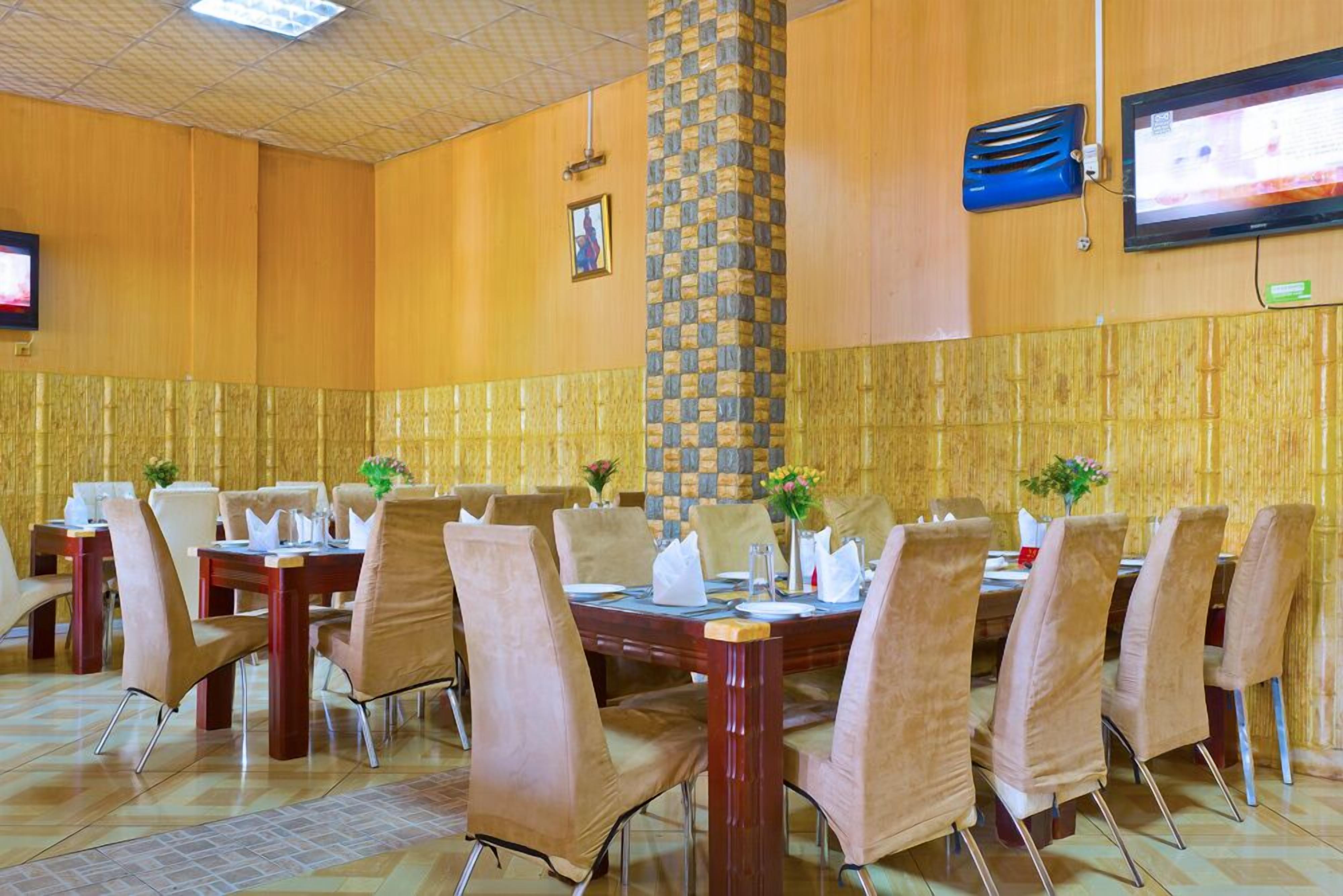 A conference room with a large table, multiple chairs, and a pillar.