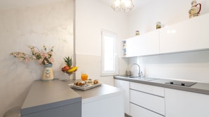 A modern kitchen with white cabinets, a countertop, and a window. - Villa Boro 2 (Dubrovnik)