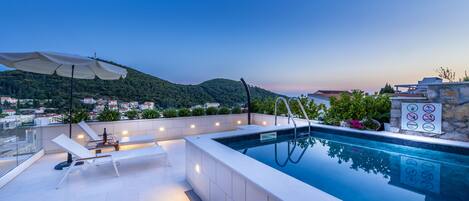 Seasonal outdoor pool, pool umbrellas, pool loungers