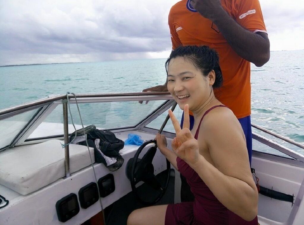 A person on a boat with a view of the sea.