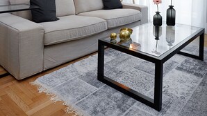 A modern living room with a sofa, a glass coffee table, and a floor lamp. - Lux Central Apartment At Kolonaki (Athens)