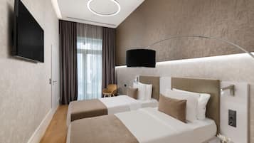 A modern hotel room with two beds, a flat-screen TV, a bedside table, and a large window with curtains.