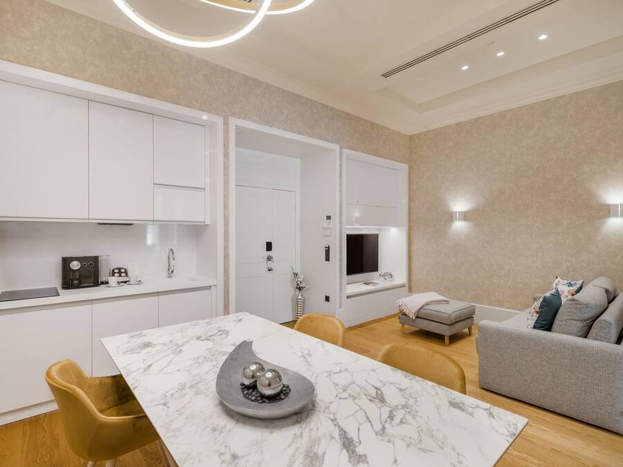 A modern living room with a marble table, a sofa, and a TV.