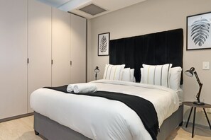 Premium bedding, desk, laptop workspace, iron/ironing board