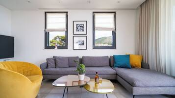 Luxury Apartment | Living area | 60-cm flat-screen TV with cable channels, LCD TV, Netflix