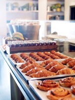A bakery display with various pastries and baked goods.
