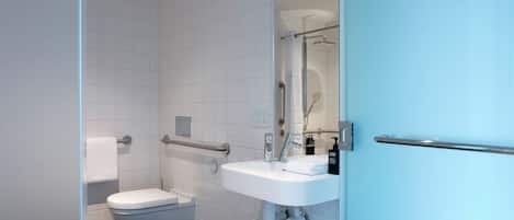 A modern bathroom with a toilet, sink, and shower.