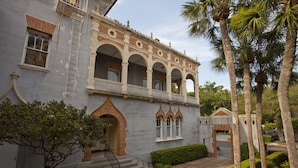 A building with a grand entrance, multiple arches, and a staircase leading to the main entrance.