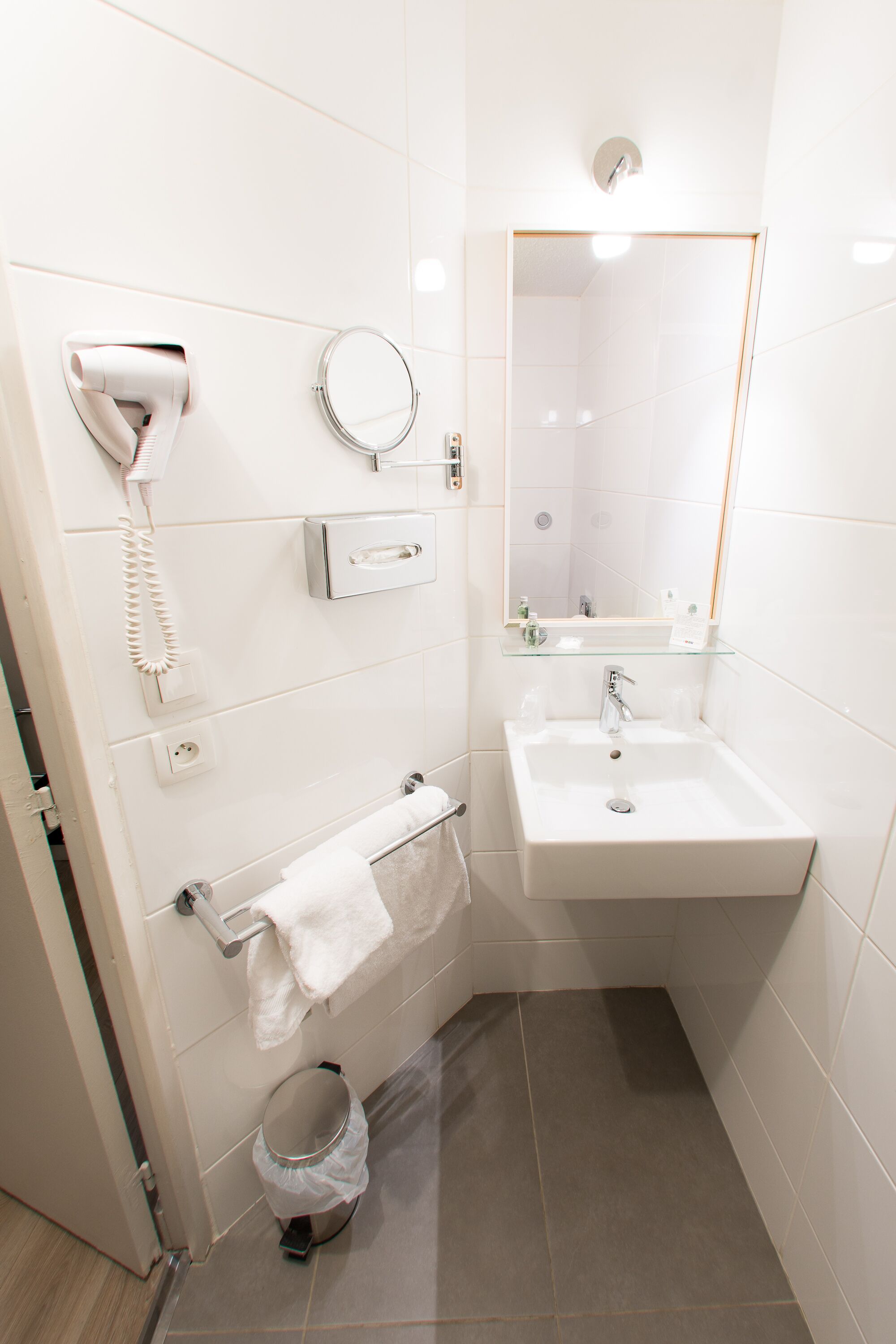 shower, hair dryer, slippers, towels