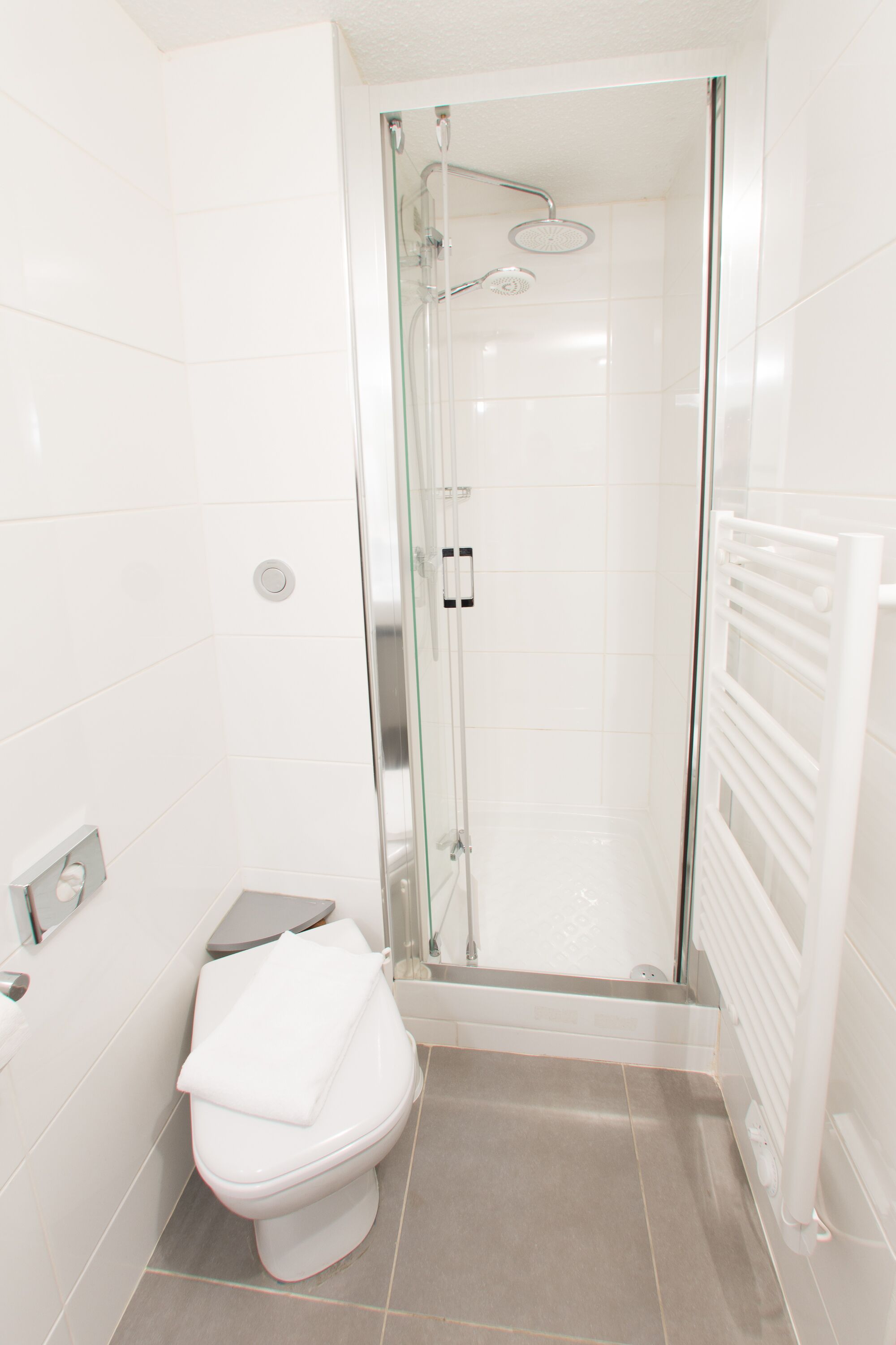 shower, hair dryer, slippers, towels