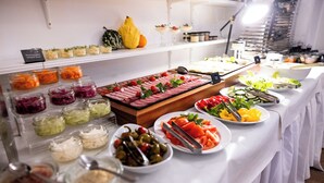 A buffet with various food items including salads, meats, and vegetables.