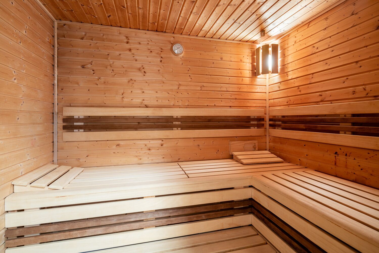 A sauna with wooden walls and benches.