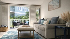 Een woonkamer met een beige bank, een houten salontafel en een blauw tapijt met patroon. Er is een balkon met witte hekwerk en uitzicht op een blauw gebouw en groen.