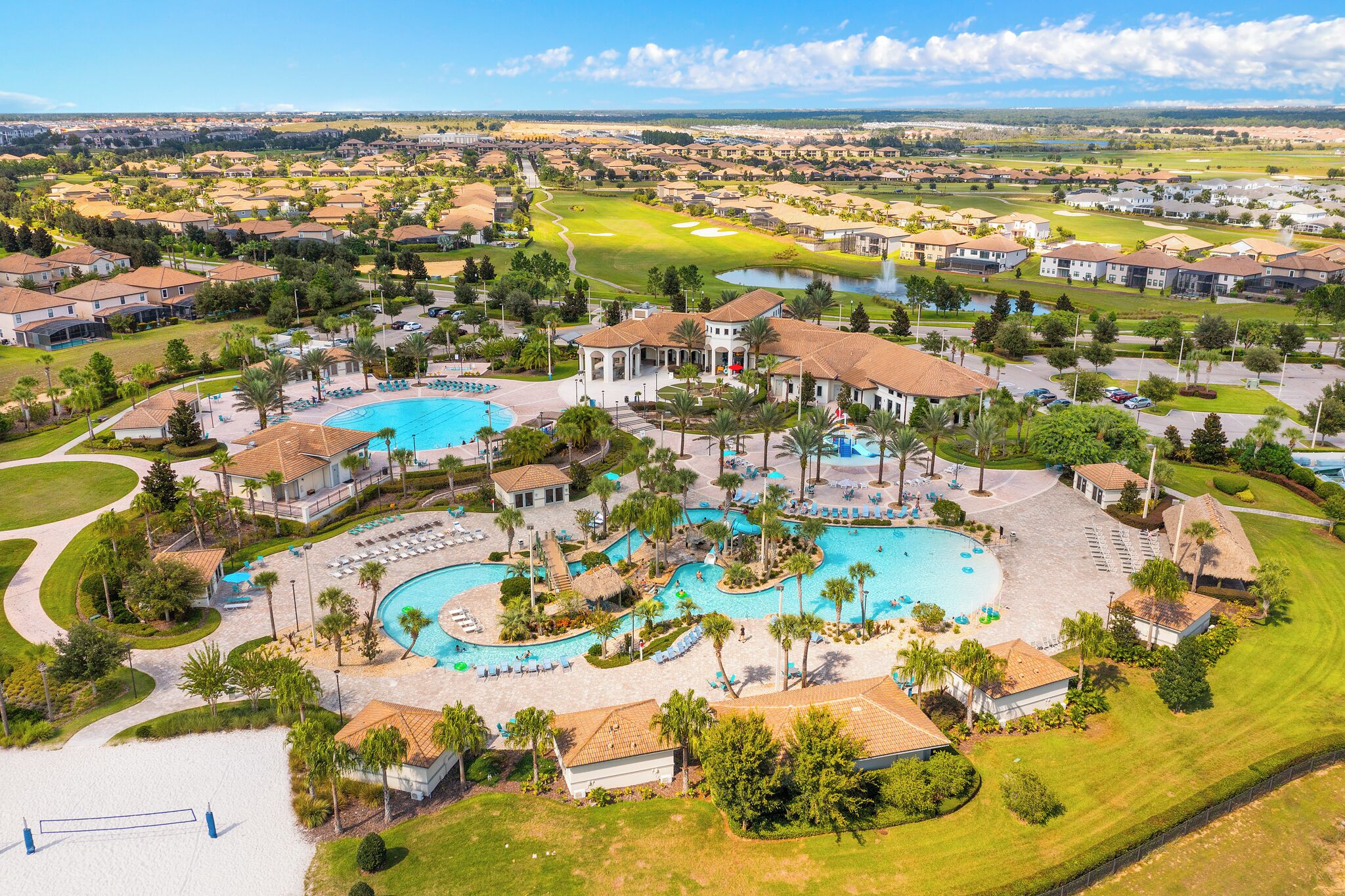 A resort with multiple swimming pools, a golf course, and residential buildings.
