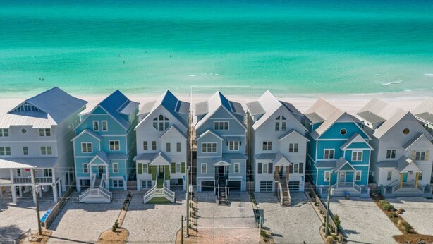 A beachfront hotel with multiple-story buildings, a sandy beach, and a clear view of the ocean. - "Soul Surfer" Dream Vacation Home w/ Direct Beach Access on the East End of Panama City Beach. Private Pool, Game Room, Large Suites + More! (Panama City Beach)