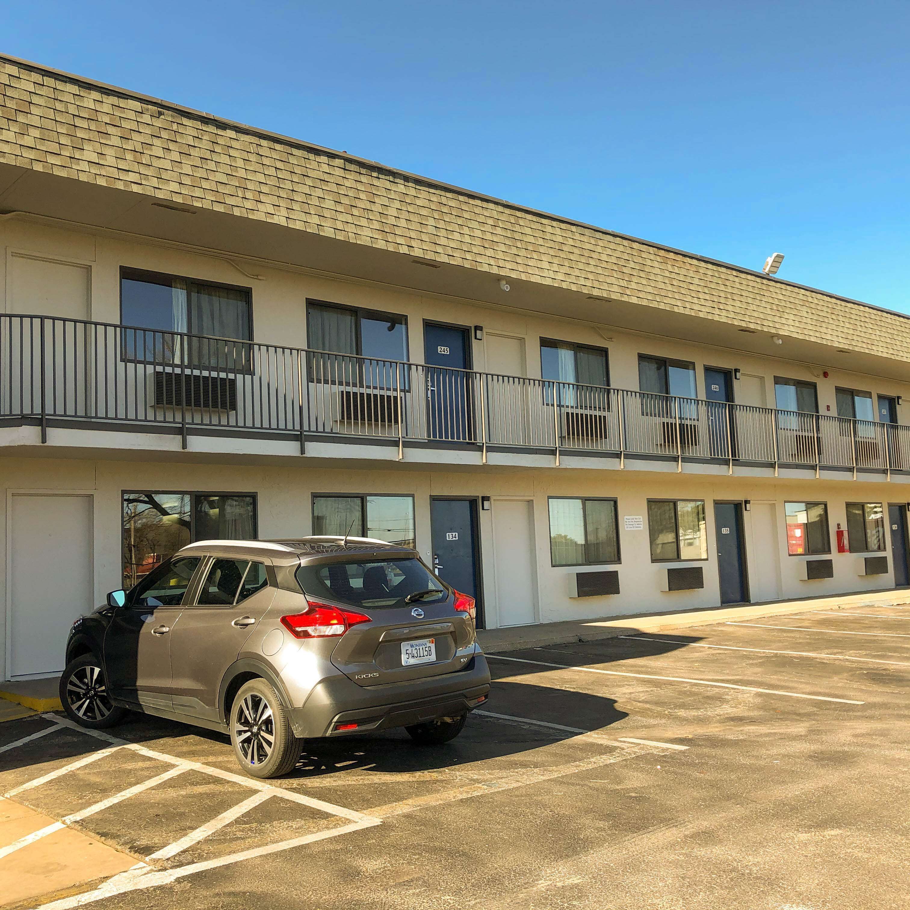 A multi-story hotel with a parking lot.