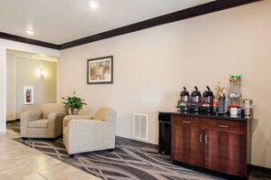 Welcome to our hotel lobby, featuring a reception desk, coffee station, and comfortable seating area.