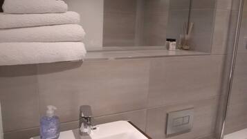 Combined shower/tub, hair dryer, towels, soap