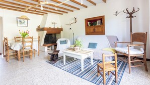 A cozy living room with a fireplace, wooden furniture, and a striped rug. - Estuvi - La Sittelle Enchantée, a break in the countryside. bike shelter, animals ok  (CHEMENOT)